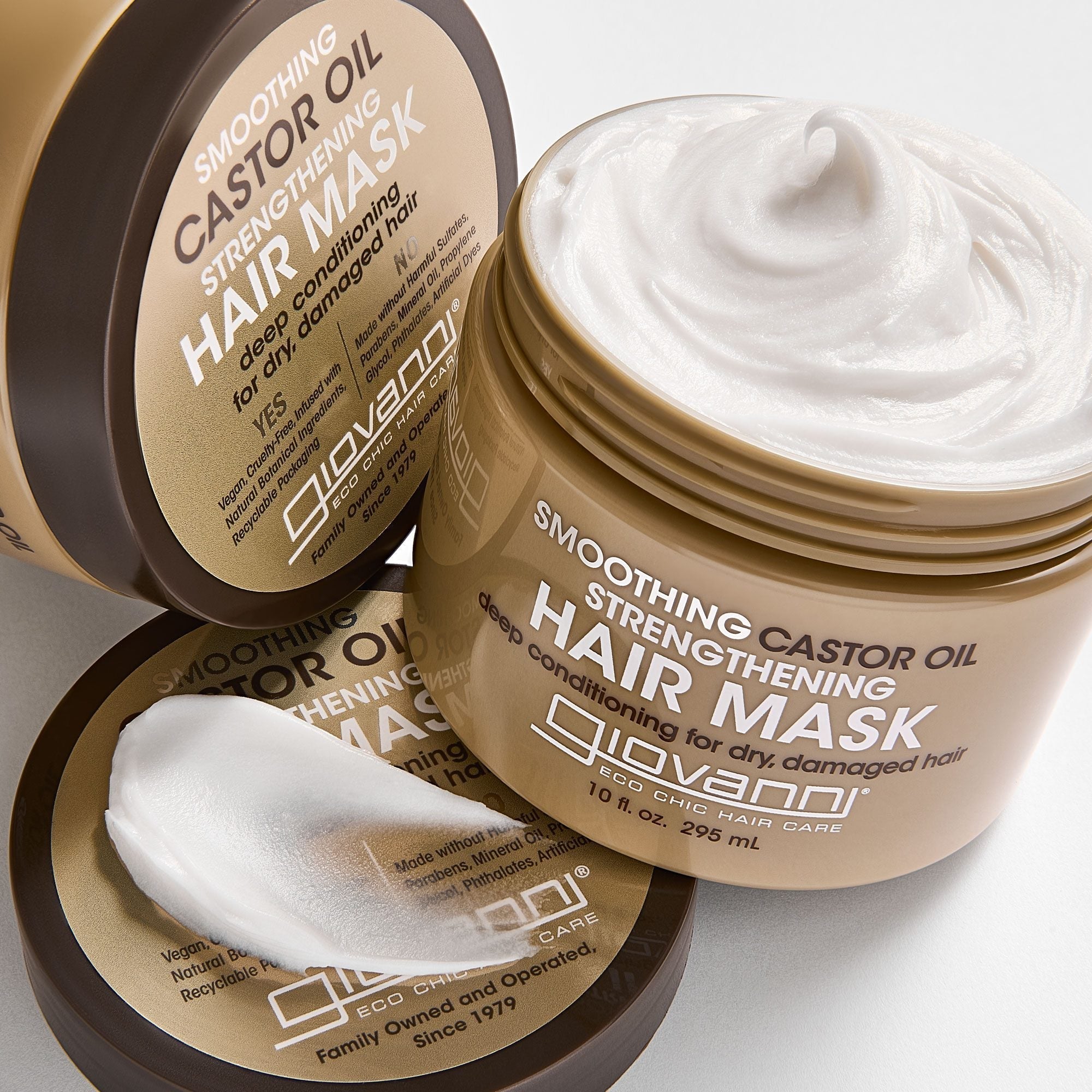 Two jars of Giovanni Smoothing Castor Oil Strengthening Hair Mask. One is open to show the creamy white texture of the mask.