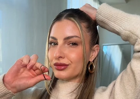 Model Caitlyn putting hair into half up half down style