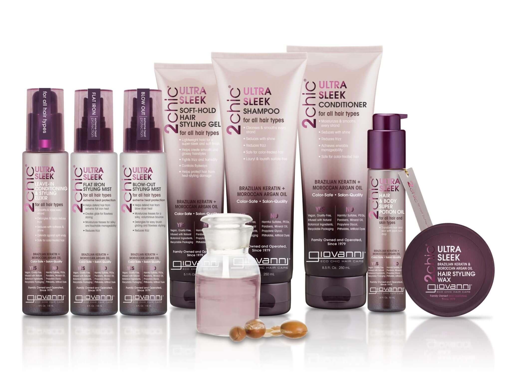 A lineup of Giovanni 2chic Ultra Sleek haircare products, including shampoo, conditioner, mists, gels, and creams, displayed with a small glass jar and a few brown nuts in front.