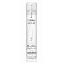 A clear spray bottle of Giovanni Cosmetics L.A. HOLD™ HAIR SPRITZ, a maximum hold, color-safe hair spray with salon-quality care, features a white label with black and purple text and a clear cap, standing upright on a white background.