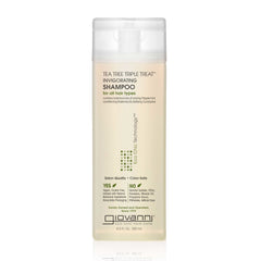 A clear bottle of Giovanni Cosmetics TEA TREE TRIPLE TREAT™ INVIGORATING SHAMPOO with a white cap. The label notes it’s salon-quality, color-safe, for all hair types, and free of sulfates and parabens. Available in 2 sizes.