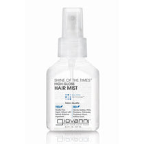 A clear plastic spray bottle labeled SHINE OF THE TIMES™ HIGH GLOSS HAIR MIST by Giovanni Cosmetics features salon-quality, eco-friendly, and color-safe claims, set against a clean white background.