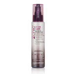 A bottle of Giovanni Cosmetics 2chic® ULTRA-SLEEK FLAT IRON STYLING MIST, enriched with Brazilian Keratin and Moroccan Argan Oil, featuring a purple spray cap and a gradient white-to-pink label.
