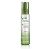 A green and white 4 fl oz bottle of Giovanni Cosmetics 2chic® ULTRA-MOIST DUAL-ACTION PROTECTIVE LEAVE-IN SPRAY for dry hair, with nourishing avocado and olive oil; benefits and ingredients are listed on the label.