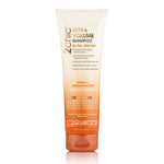 A tube of 2chic Ultra-Volume Shampoo by Giovanni, with a creamy beige body and orange tint at the base, against a white background.