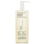 A bottle of Giovanni Cosmetics TEA TREE TRIPLE TREAT™ INVIGORATING SHAMPOO features a pump dispenser and beige label, highlighting this color-safe, paraben-free formula’s salon-quality and eco-friendly benefits. Available in 2 sizes.