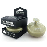 The SCALP MASSAGER & SHAMPOO BRUSH (Tan Handle) by Giovanni Cosmetics is a round, light olive scalp brush with a handle, shown next to its black box—ideal for natural hair care and stress relief.