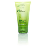 A travel-size tube of Giovanni Cosmetics 2chic® ULTRA-MOIST SHAMPOO, in green and yellow packaging, nourishes and protects dry, damaged hair. This color-safe shampoo helps restore strands while displaying product details on the front.