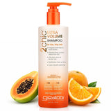 A bottle of Giovanni Cosmetics 2chic® ULTRA-VOLUME SHAMPOO - 2 Sizes stands upright, accented with an orange pump and label, surrounded by papaya and orange slices—highlighting papaya and tangerine butter for fine hair.