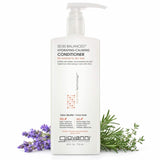 A gallon-sized white bottle of Giovanni Cosmetics 50:50 BALANCED™ HYDRATING-CALMING CONDITIONER stands upright with a pump beside lavender and rosemary sprigs on a white background. This color-safe conditioner hydrates and calms hair.