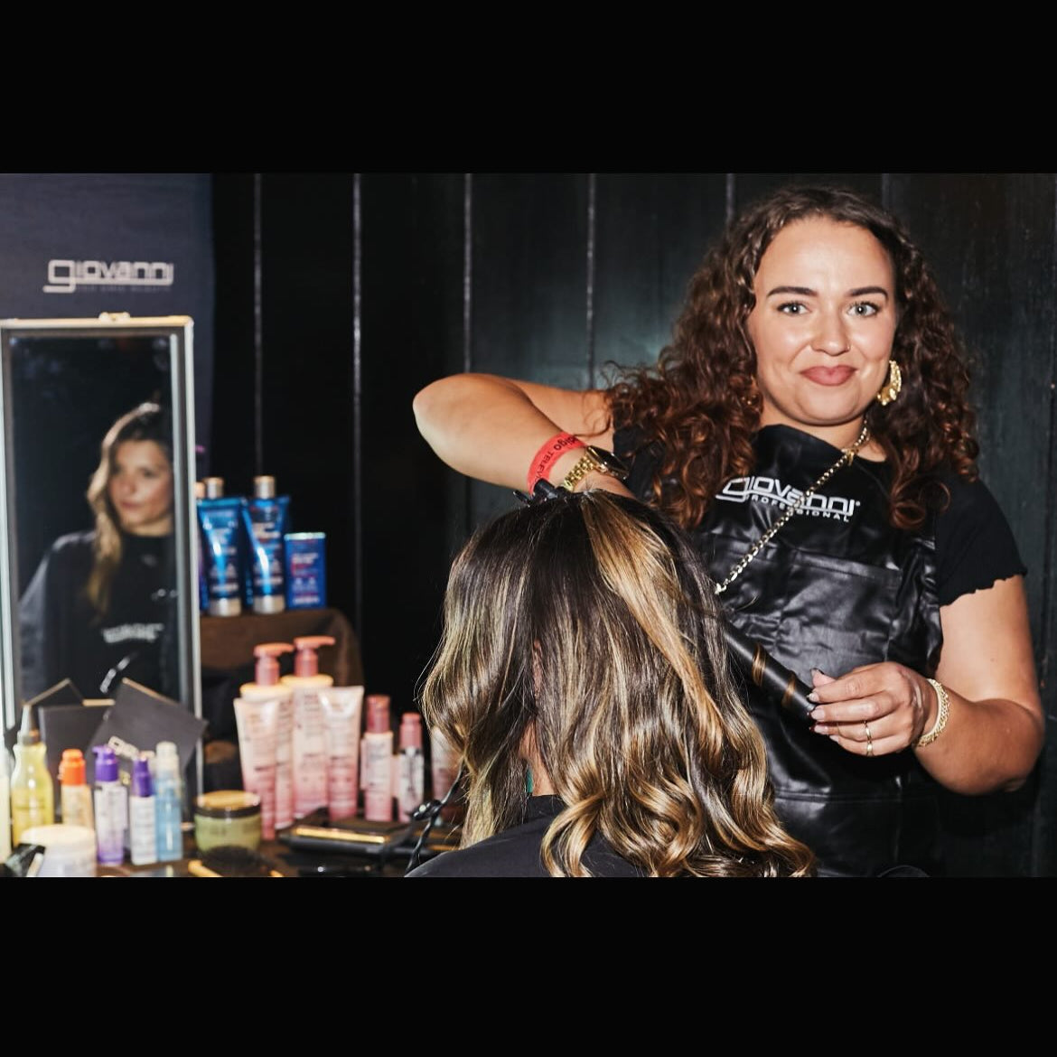 Woman getting her hair styled back stage at the National Television Awards