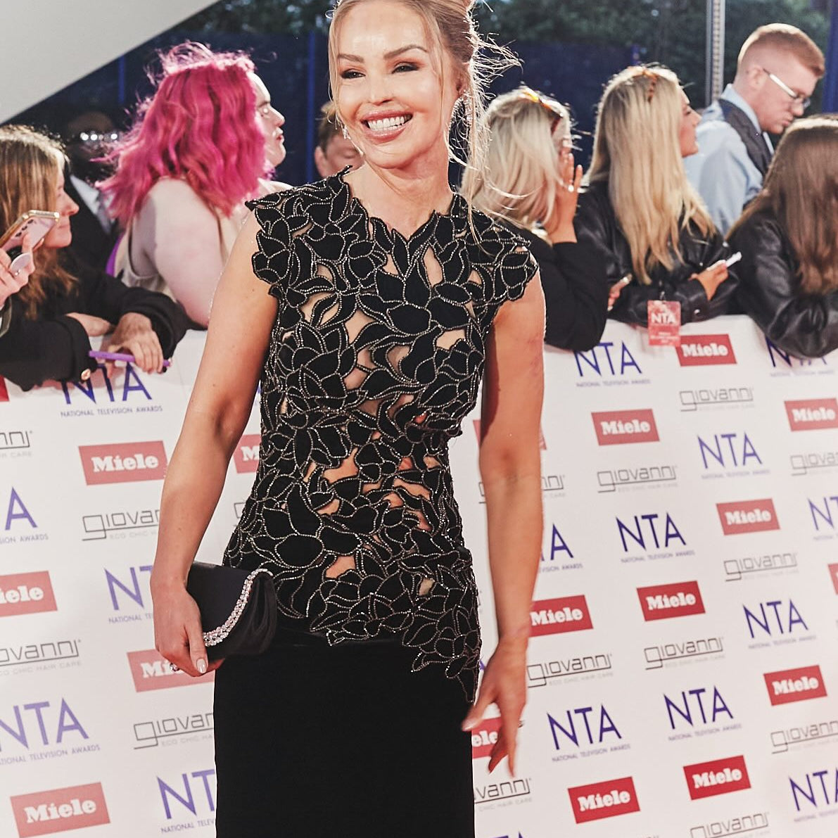 Woman in a black dress on the red carpet at the National Television Awards