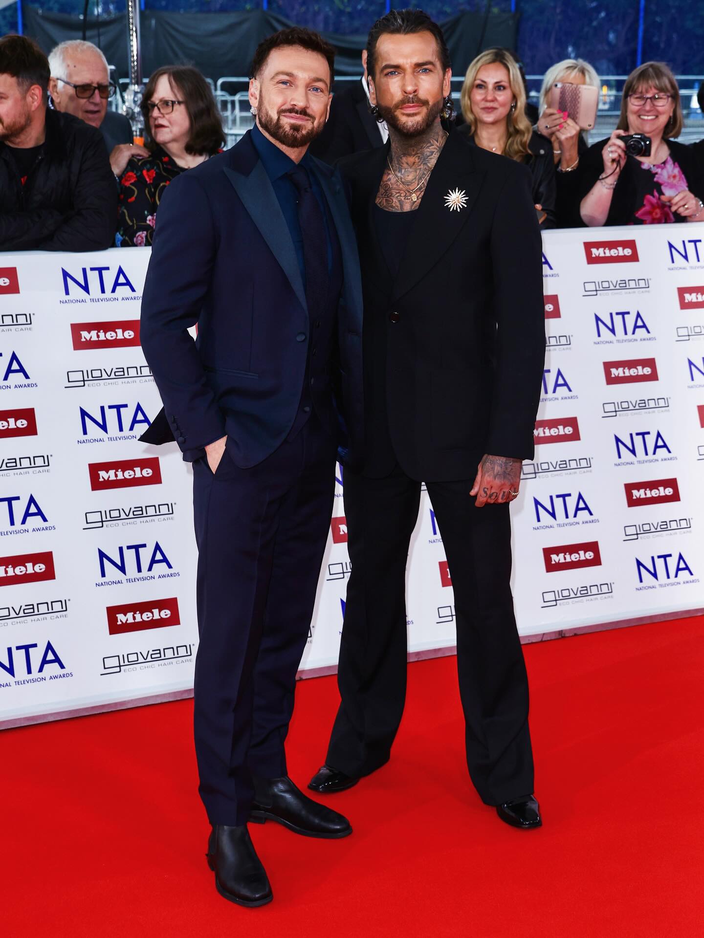 Two men posing on the red carpet at the National Television Awards