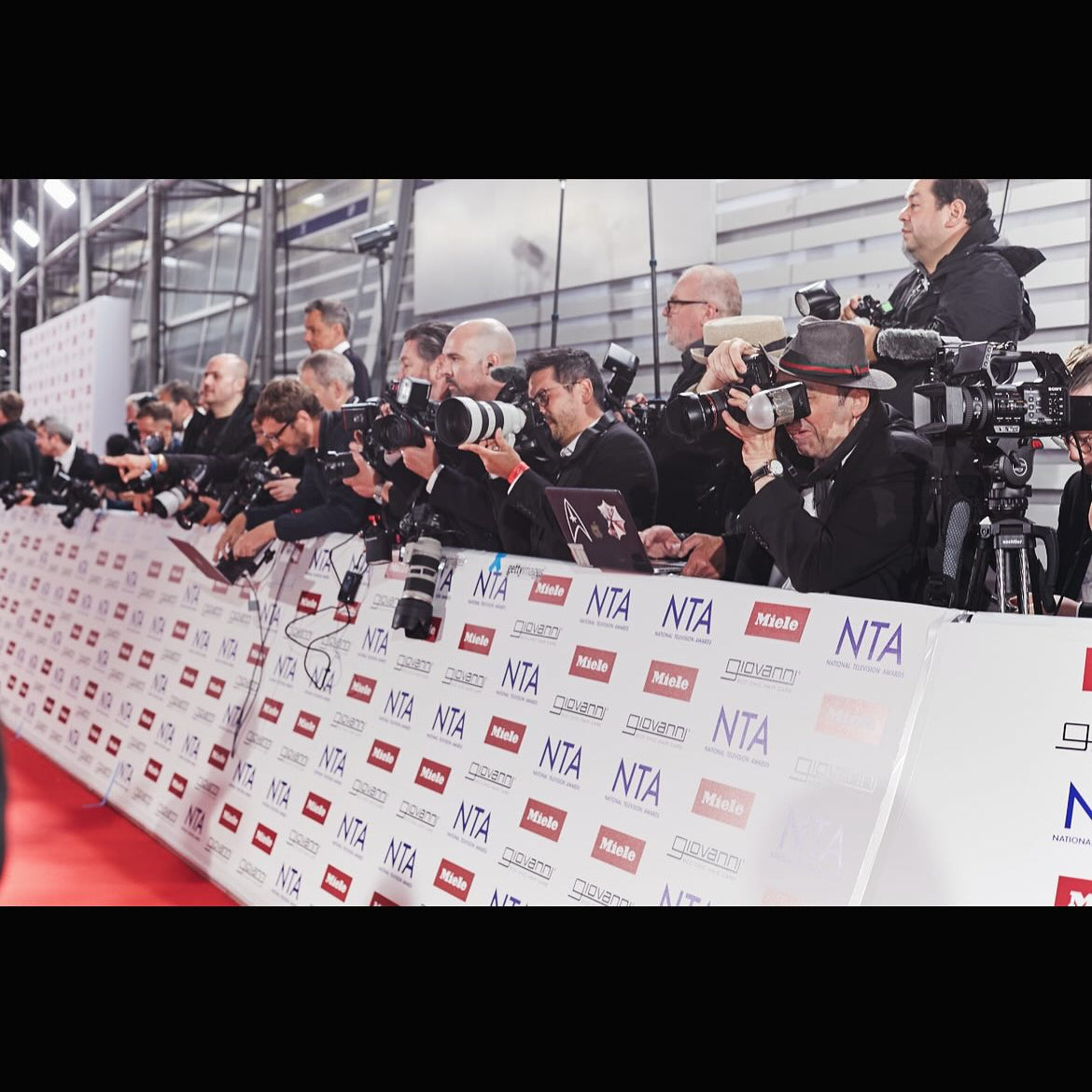 Journalists with cameras at the red carpet at the National Television Awards