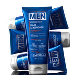 A tube of Giovanni Cosmetics MEN Strong Hold Hair Styling Gel with Ginseng and Eucalyptus stands upright, surrounded by identical blue tubes—showcasing salon-quality hair care and a strong hold formula for men.