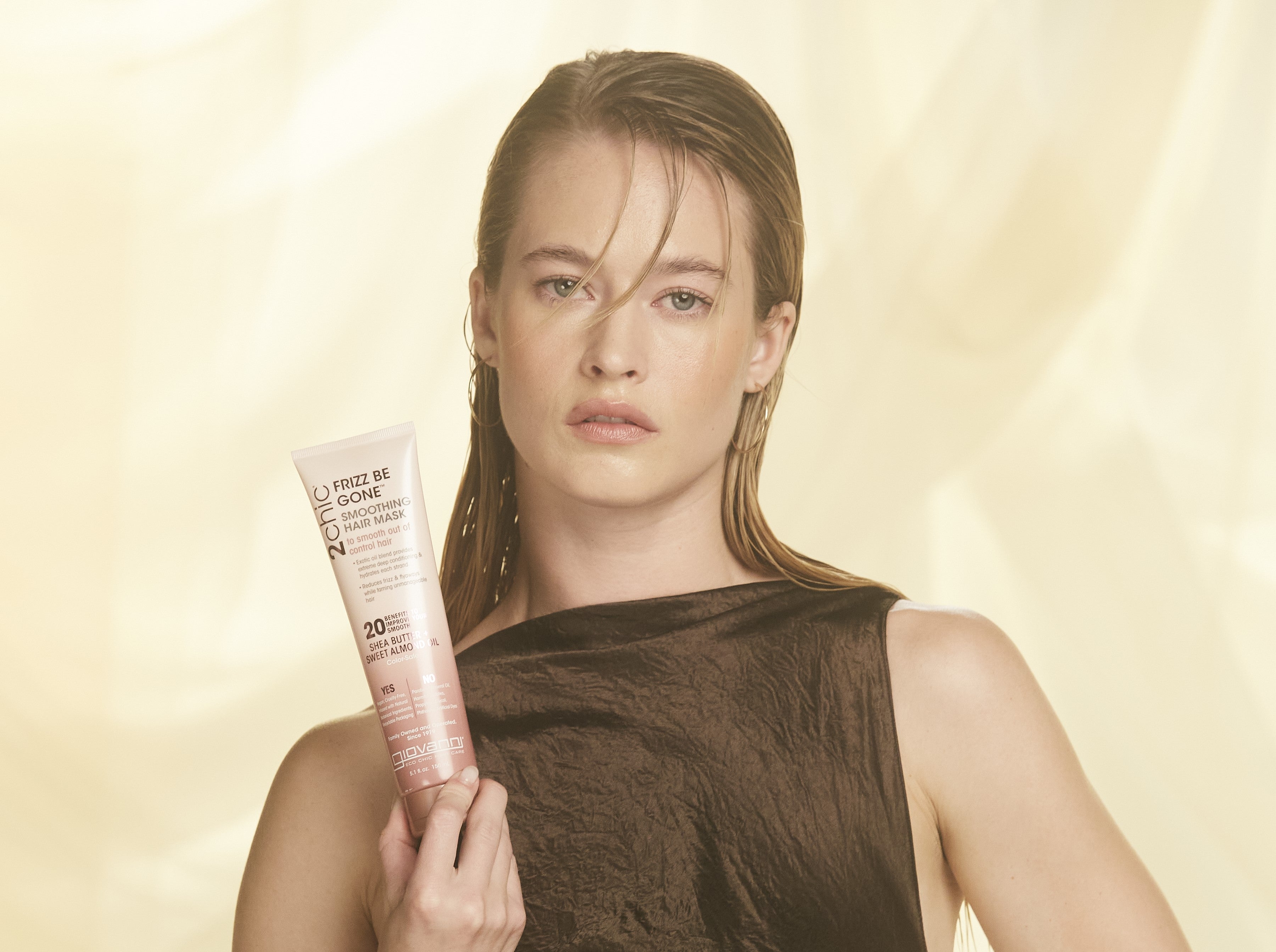 Woman holding Giovanni 2Chic Frizz Be Gone Smoothing Hair Mask
