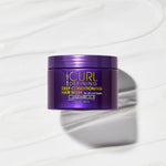A purple container of Giovanni Cosmetics CURL HABIT™ CURL DEFINING DEEP CONDITIONING HAIR MASK sits on a creamy white background, highlighting its hydrating, curl-enhancing, and moisturizing formula.