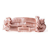 The HEATLESS SATIN HAIR CURLING SET (blush) by Giovanni Cosmetics is displayed on a white background, featuring a soft pink satin curling rod along with two matching scrunchies and a large hair clip—ideal for creating smooth, frizz-free curls without any heat damage.