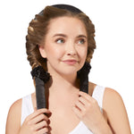 A light-skinned woman with wavy blonde hair wraps her hair around Giovanni Cosmetics' HEATLESS SATIN HAIR CURLING SET in black for heatless curls. Wearing a white tank top, she smiles softly, looking to the side against a white background.