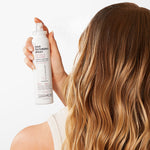 Giovanni Hair Texturizing Spray being sprayed on woman's hair