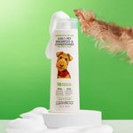 A bottle of Giovanni Cosmetics PROFESSIONAL 2-IN-1 PET SHAMPOO & CONDITIONER – TEA TREE & ALOE sits on a sudsy white platform with a dog’s soapy paw in view, set against a green background to highlight gentle pet care.