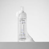 A clear bottle of Giovanni Cosmetics MOUSSE AIR-TURBO CHARGED™ HAIR STYLING FOAM with white mousse overflowing from the pump, set against a plain white background.