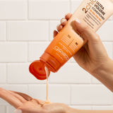 Hands holding bottle of Giovanni 2chic Ultra Volume Conditioner