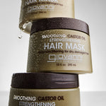 3 bottles of Smoothing Castor Oil Strengthening Hair Mask stacked on top of each other with water drops