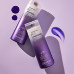 A bottle of Giovanni Cosmetics COLOR CHIC™ PURPLE CONDITIONER rests on a purple surface with conditioner swatches nearby—ideal for enhancing blonde tones or maintaining silver hair, all styled in soft, angled lighting.