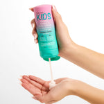 Hands holding a bottle of Giovanni Eco Chic Kids Styling, Taming & Curl Cream