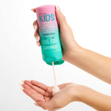 Hands holding a bottle of Giovanni Eco Chic Kids Styling, Taming & Curl Cream