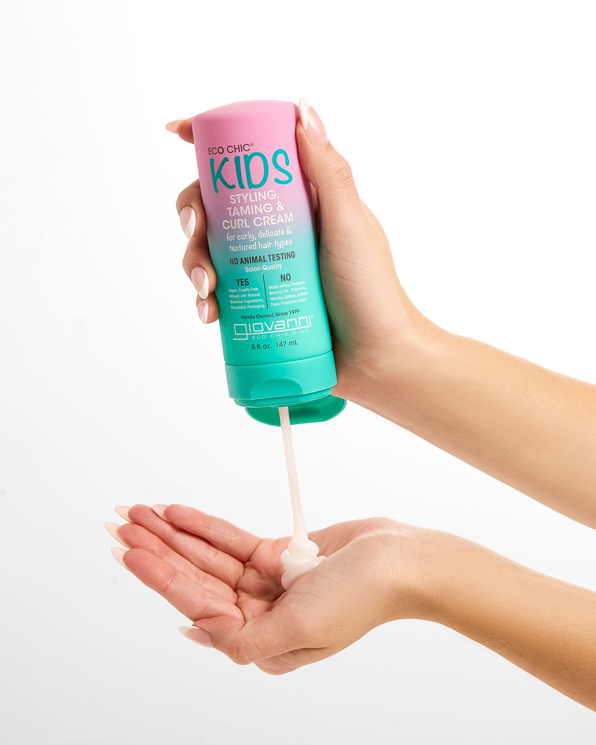 Hands holding a bottle of Giovanni Eco Chic Kids Styling, Taming & Curl Cream