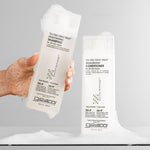 Hand holding Tea Trea Triple Treat Invigorating Shampoo and Conditioner
