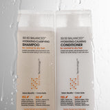Bottles of 50:50 Balanced Hydrating-Calming Conditioner and Shampoo with drips