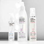 Giovanni Cosmetics' RAPID BLOW-DRY SHIELD AND STYLE SPRAY stands on a white surface, with a lit mirror in the background.