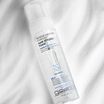 Giovanni hair styling foam bottle on a white fabric background