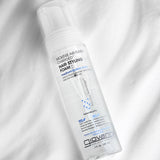 Giovanni hair styling foam bottle on a white fabric background