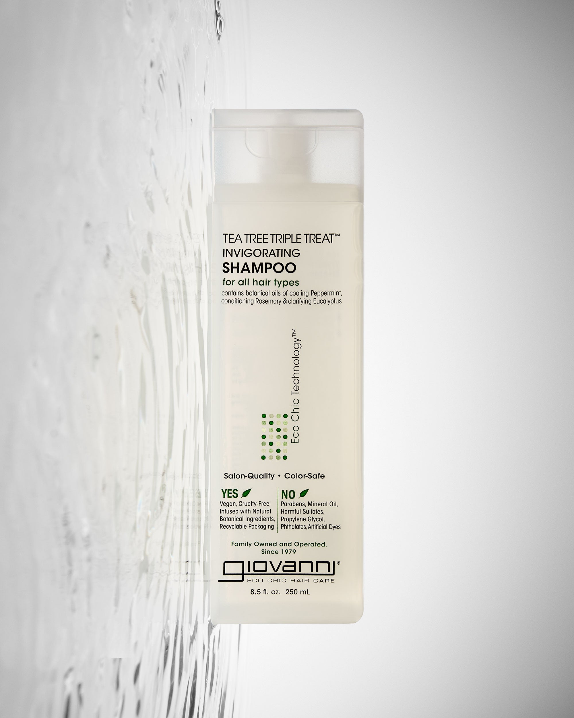 Giovanni Tea Tree Triple Treat Shampoo bottle on a light gray background