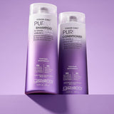 Two bottles of Giovanni Cosmetics COLOR CHIC™ PURPLE CONDITIONER for blonde, silver, gray, white, and lilac-toned hair stand side by side against a light purple background.