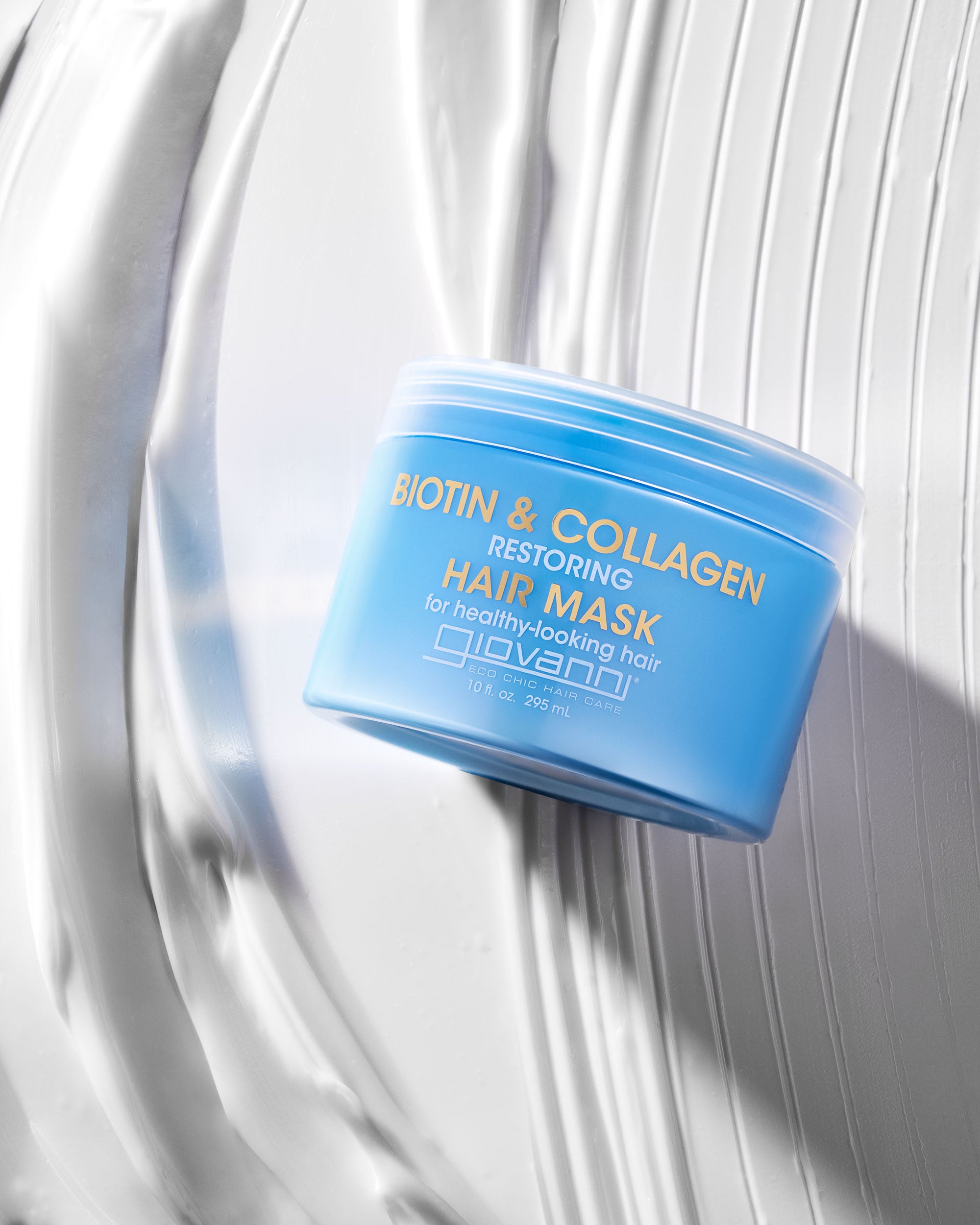 Blue container of Giovanni biotin and collagen hair mask on a white background