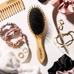 Giovanni Hairbrush, scrunchies, and accessories on a white surface