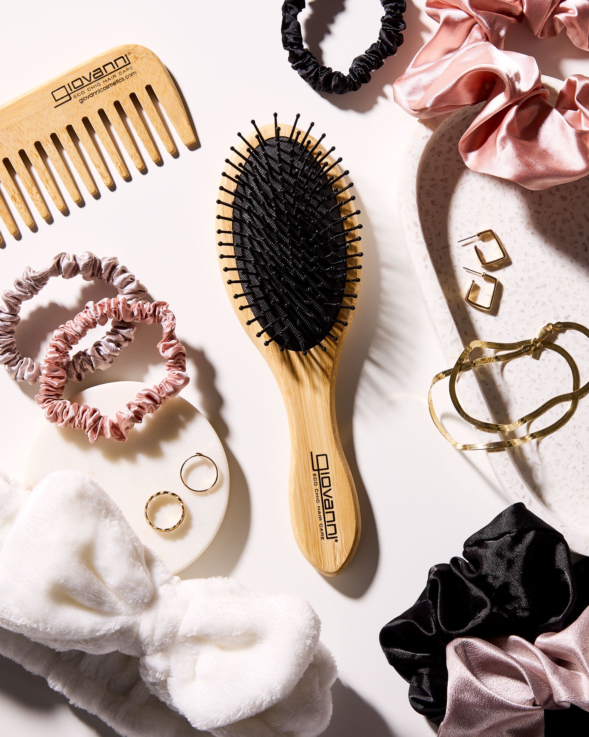 Giovanni Hairbrush, scrunchies, and accessories on a white surface
