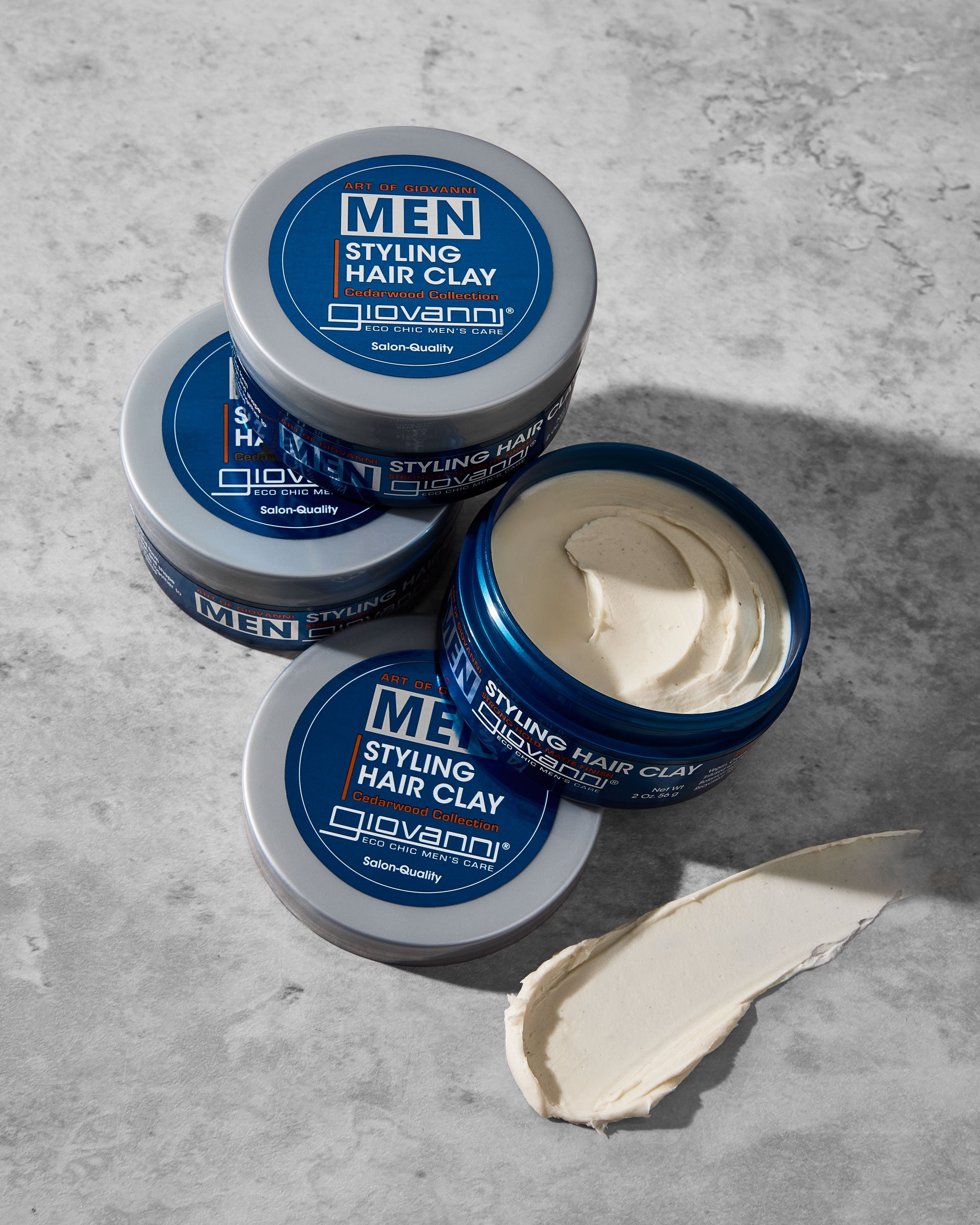 Jars of Giovanni Men Styling Hair Clay on a gray surface