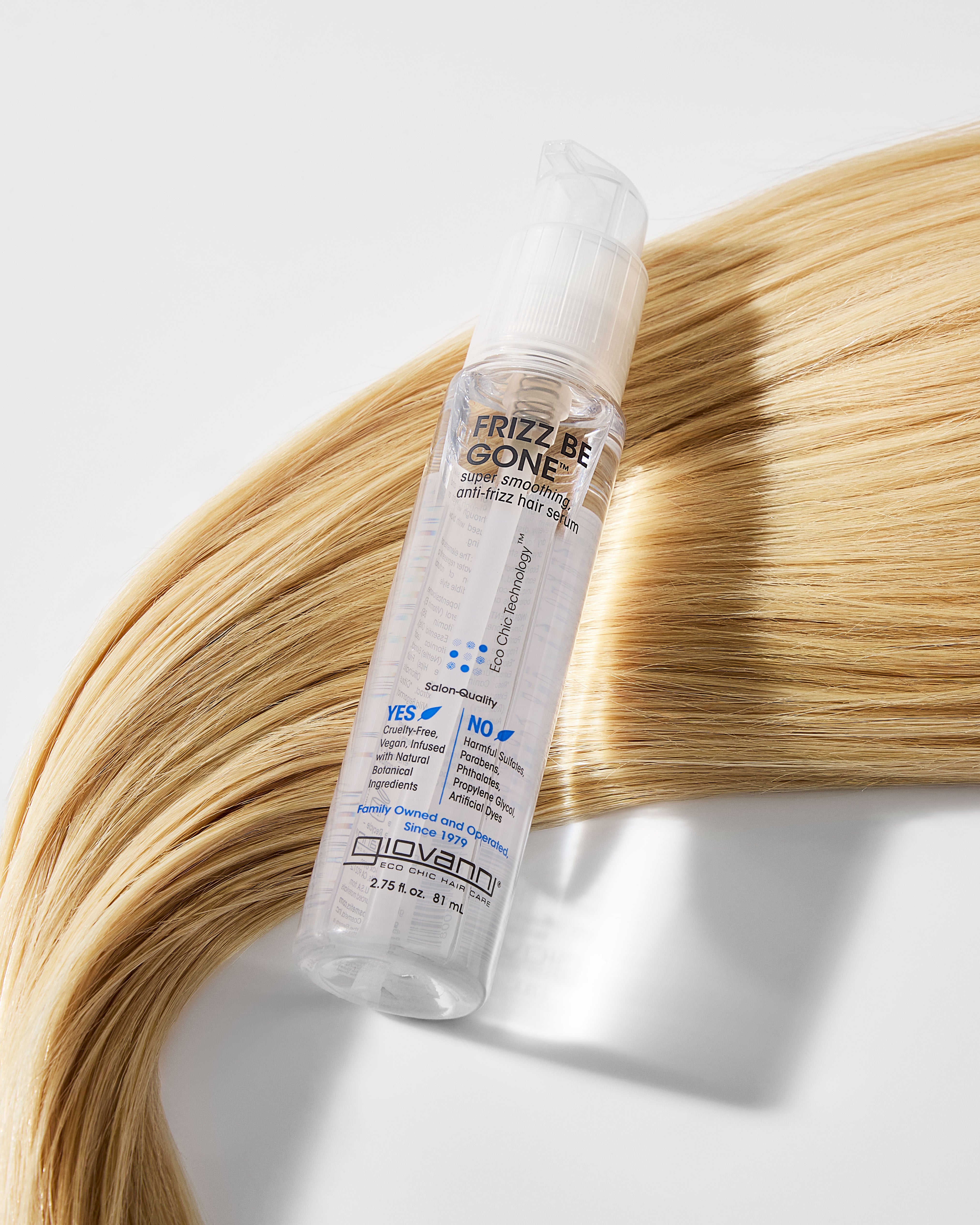 Giovanni Frizz Be Gone hair product bottle on a background of blonde hair