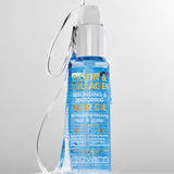 Bottle of Giovanni Biotin & Collagen hair oil on a gray background