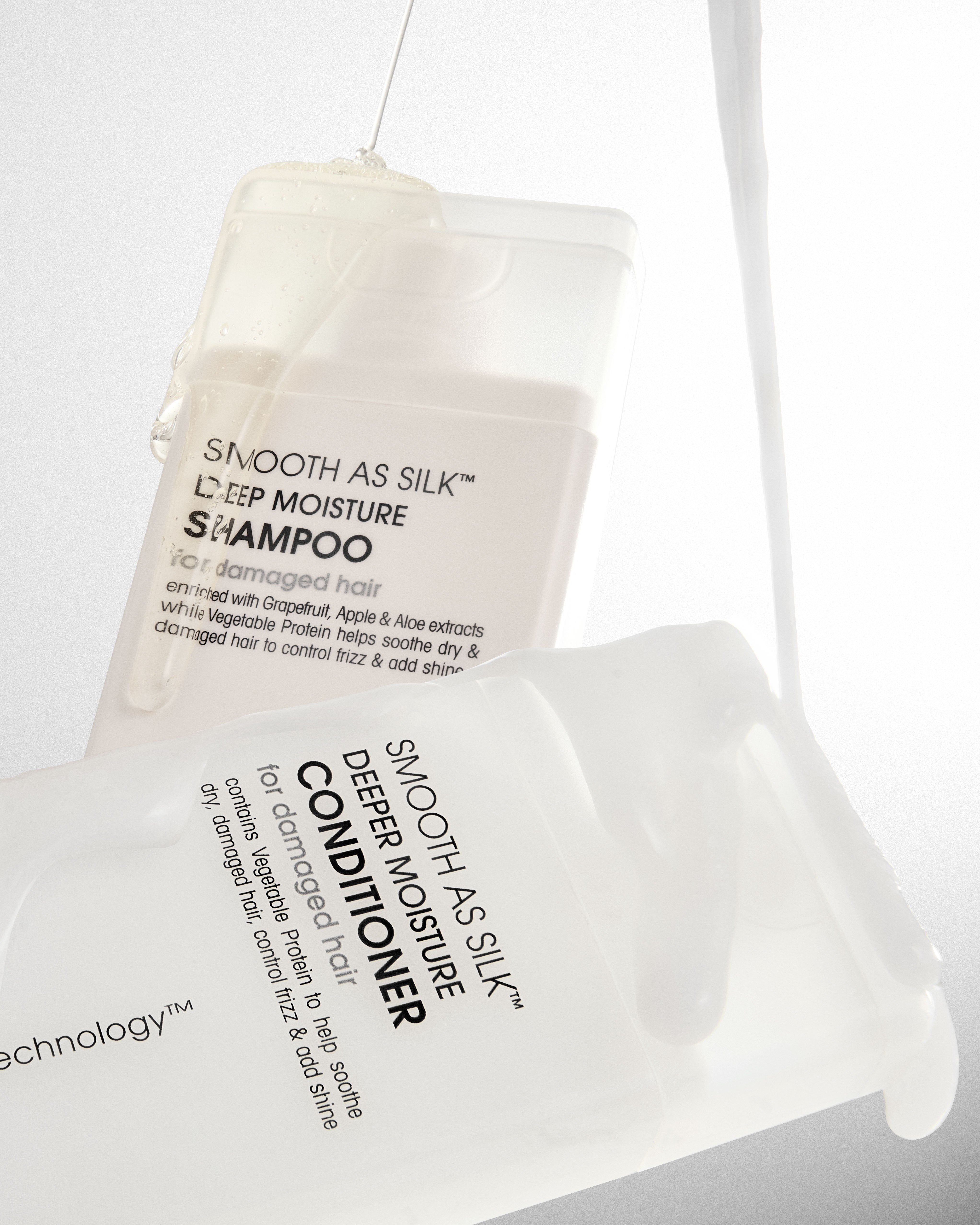 Two bottles of Giovanni Smooth as Silk shampoo and conditioner on a white background