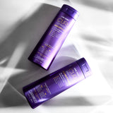 Two bottles of Giovanni CURL Habit Shampoo and Conditioner on a textured white background