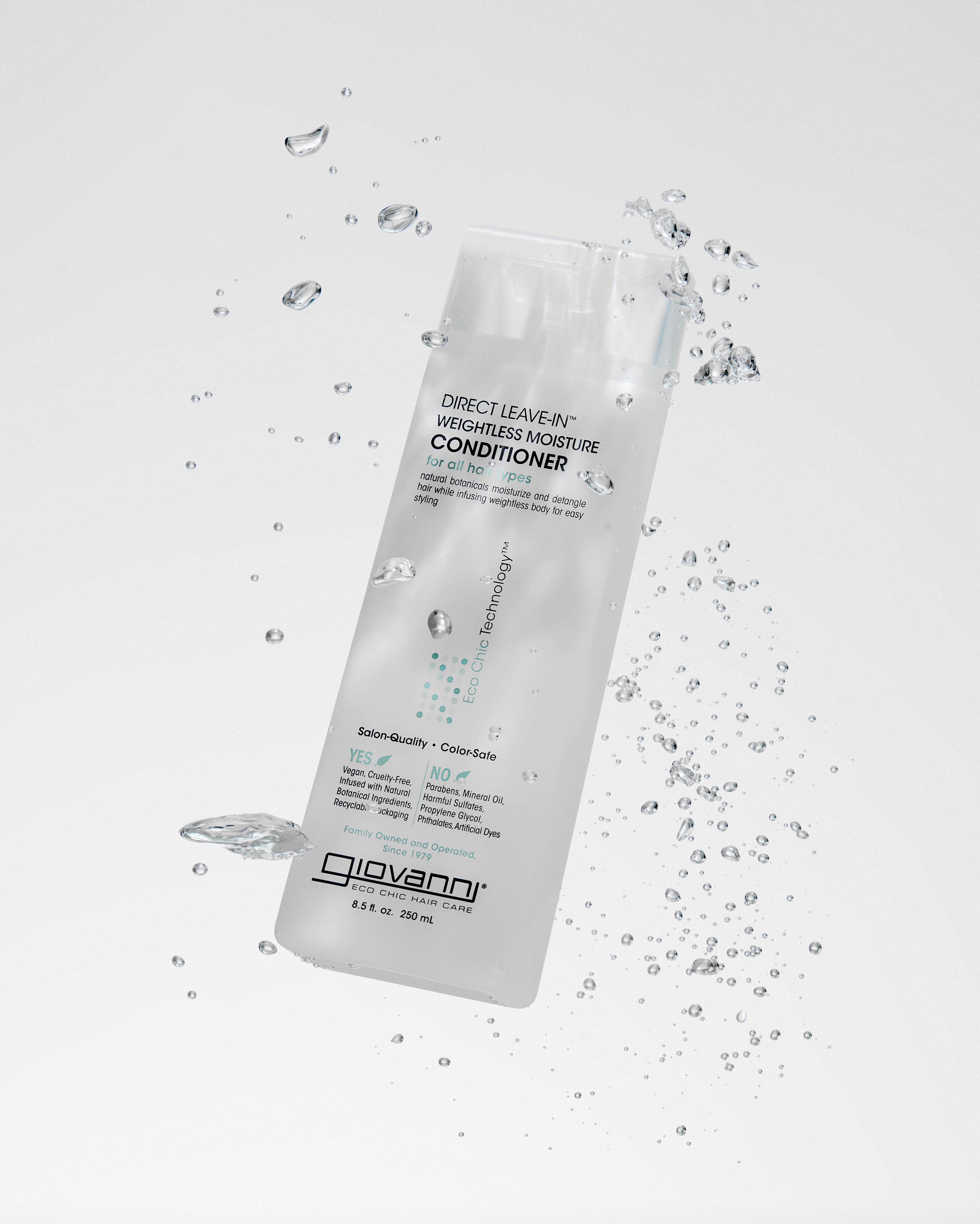 Giovanni Direct Leave-in conditioner bottle with water droplets on a light gray background