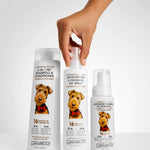 Three bottles of Giovanni pet care products with a hand holding one bottle on a light gray background