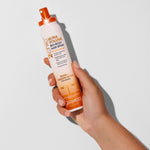 Hand holding a bottle of 2chic Ultra Volume big-body hair spray